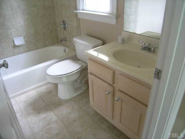 944 Oak Creek Road Raleigh, NC 27615 - Photo 17 of 20 a bathroom with a toilet sink and mirror