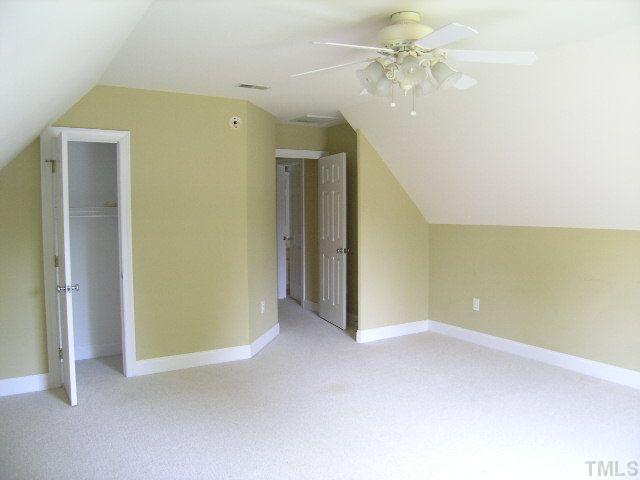 944 Oak Creek Road Raleigh, NC 27615 - Photo 19 of 20 an empty room with a ceiling fan and closet area