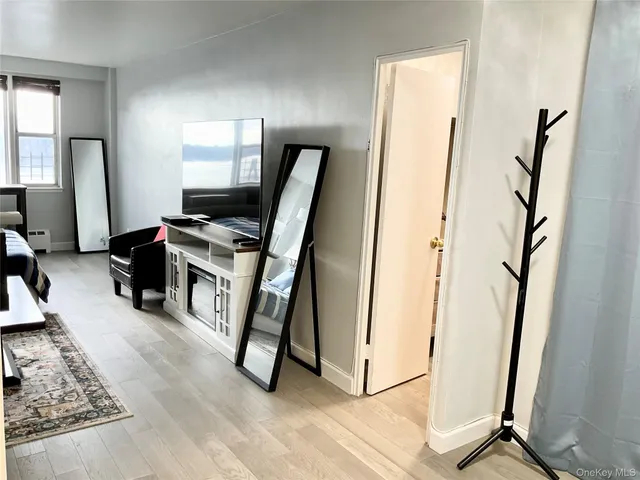a view of a livingroom with an empty space and a fireplace