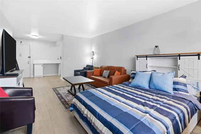 a living room with furniture a rug and a flat screen tv