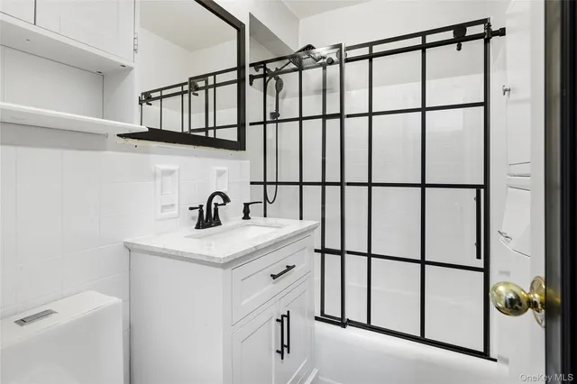 a kitchen with stainless steel appliances a stove microwave and sink