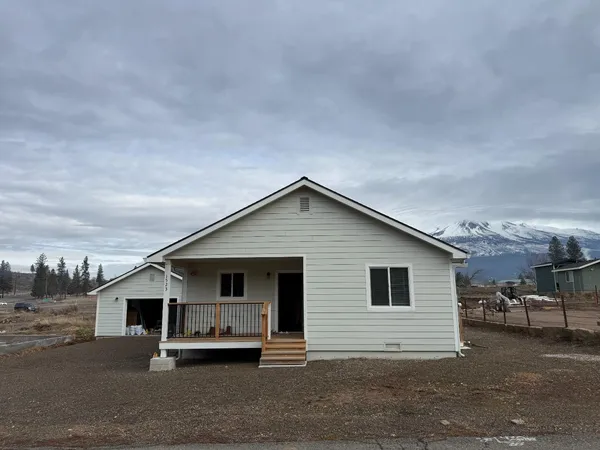 a view of a house next to a yard