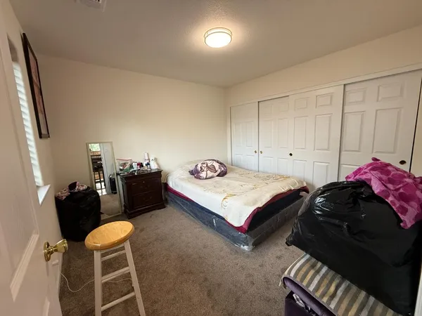a bedroom with double bed and a window
