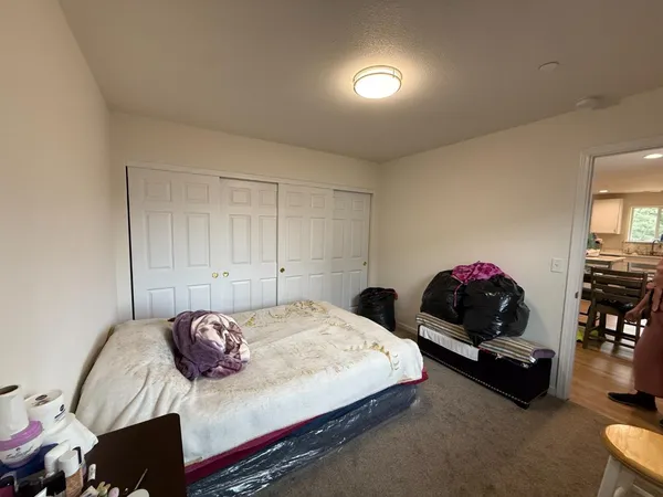 a bedroom with a bed and a couch