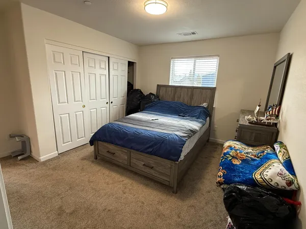 a bedroom with a bed and a window