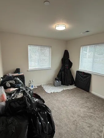 a bed room with a bed and a window