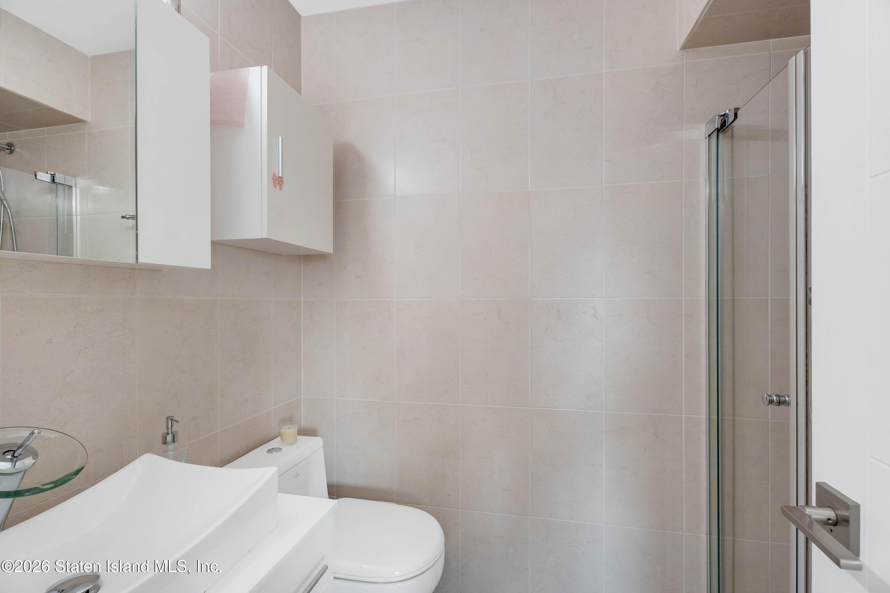 929 West Fingerboard Road Staten Island, NY 10304 - Photo 12 of 14 a white toilet sitting next to a bathroom sink