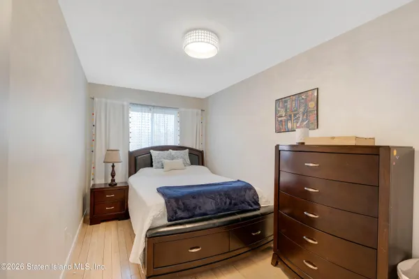 a bedroom with a bed and a mirror