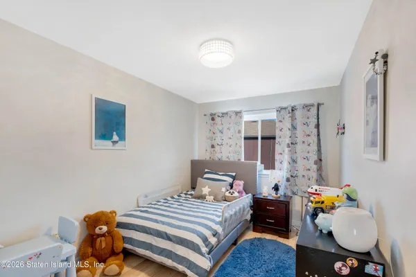 a bedroom with a bed and dresser