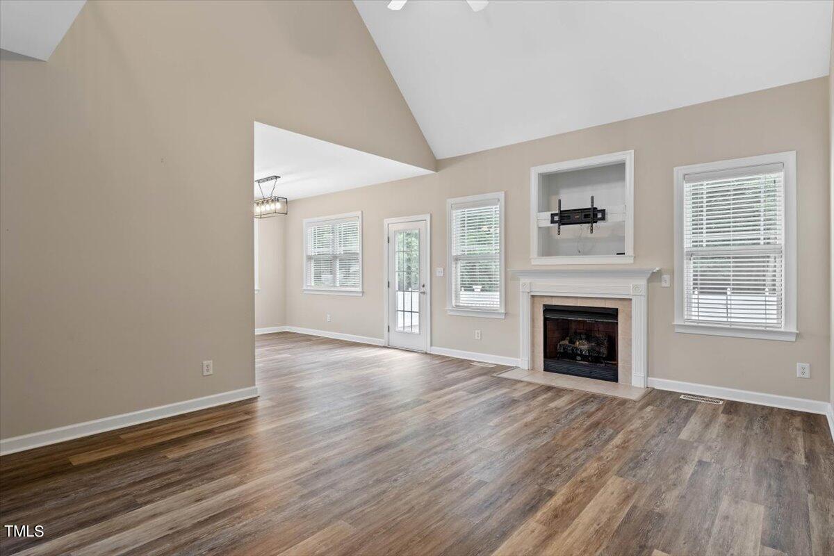 134 Blessed Lane Angier, NC 27501 - Photo 12 of 41 a view of an empty room with wooden floor and a window