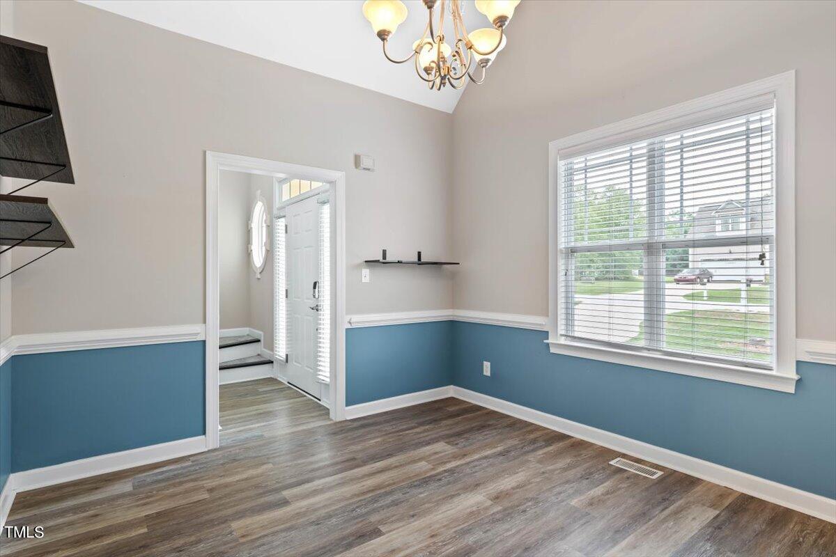 134 Blessed Lane Angier, NC 27501 - Photo 15 of 41 a view of empty room with wooden floor and fan