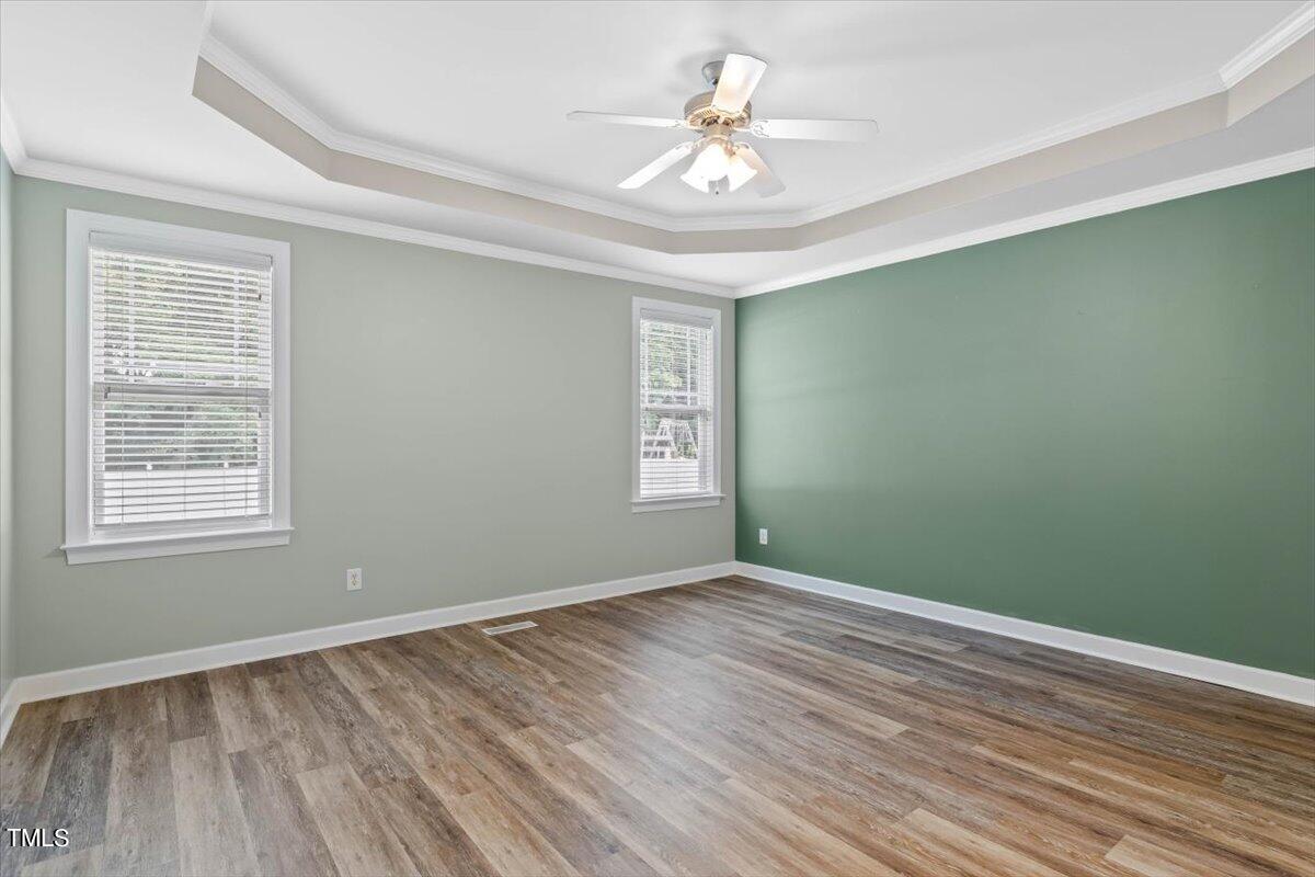 134 Blessed Lane Angier, NC 27501 - Photo 18 of 41 a view of an empty room with wooden floor and a window