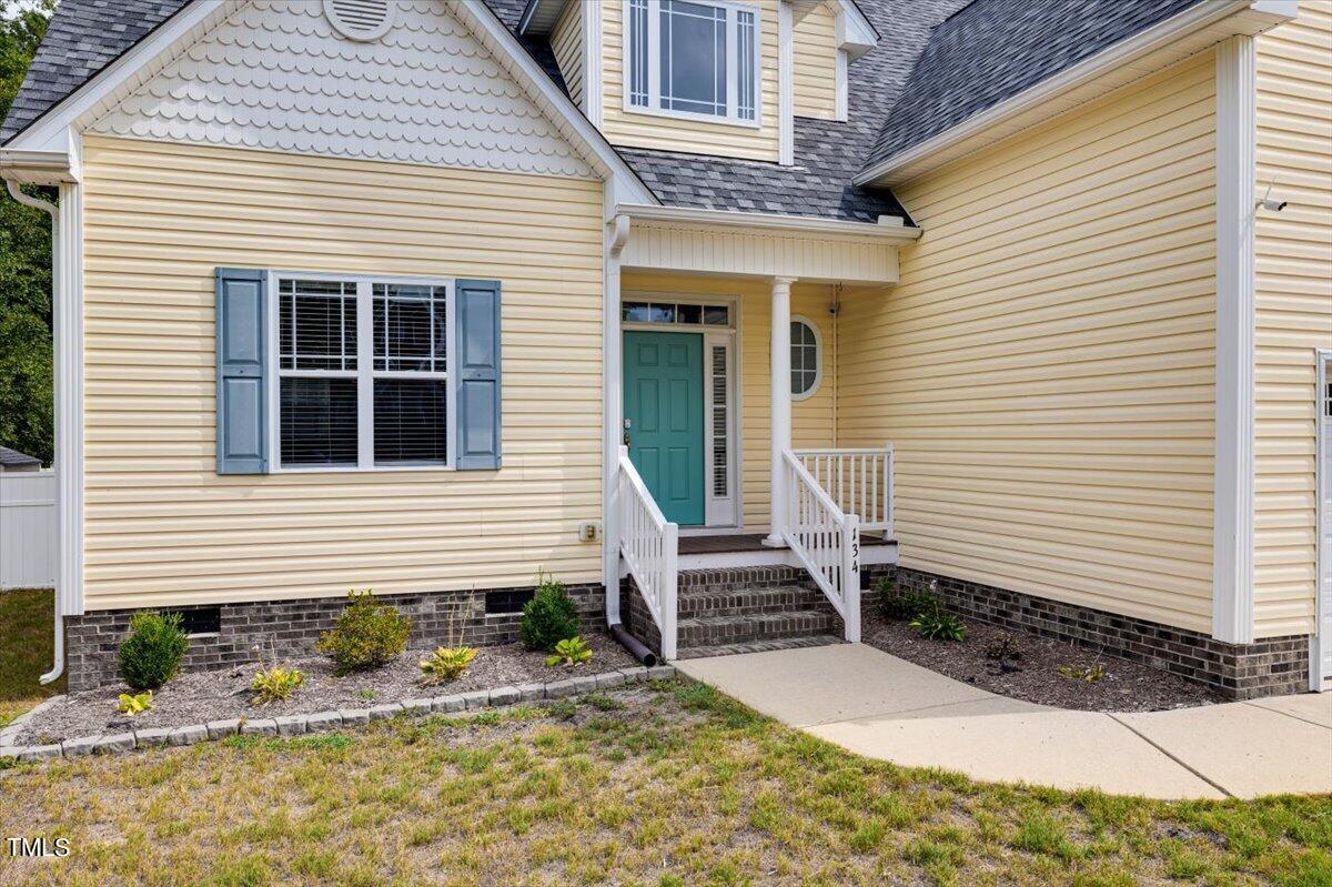 134 Blessed Lane Angier, NC 27501 - Photo 2 of 41 a view of a house with backyard and sitting area