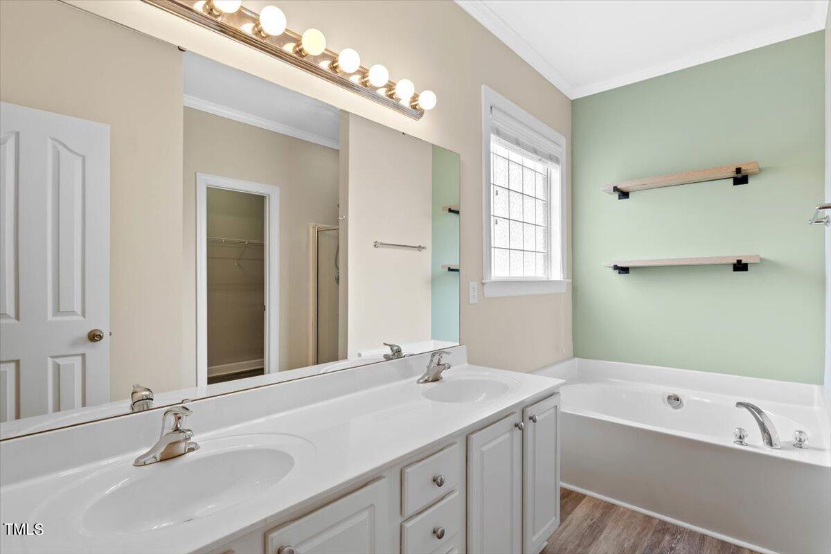134 Blessed Lane Angier, NC 27501 - Photo 21 of 41 a bathroom with a tub double vanity sink and mirror