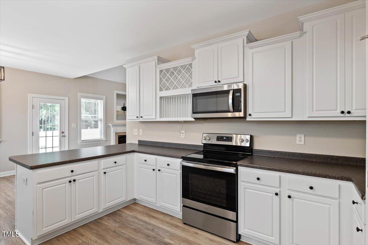 134 Blessed Lane Angier, NC 27501 - Photo 7 of 41 a kitchen with white cabinets and appliances
