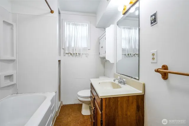a bathroom with a sink a toilet and tub