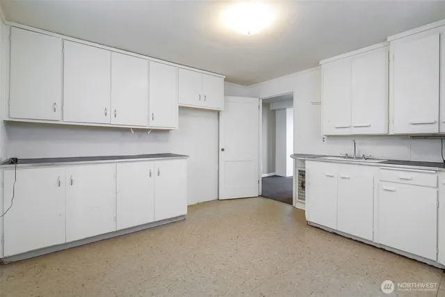 a kitchen with cabinets appliances a sink