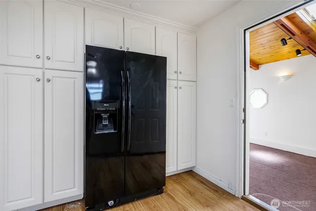 a view of walk in closet with wooden floor