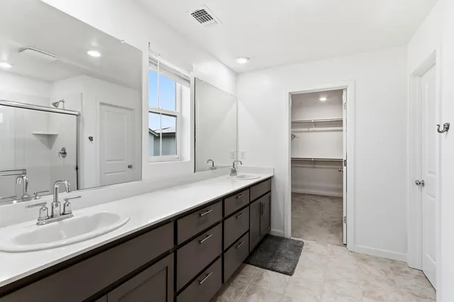 a bathroom with a double vanity sink and a mirror