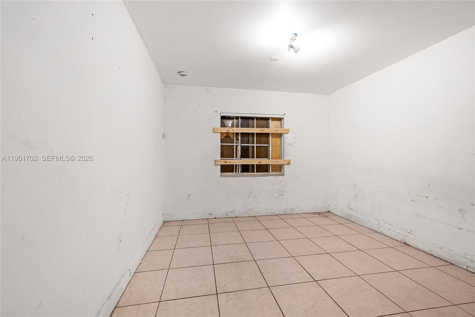 2951 Northwest 57th Street Miami, FL 33142 - Photo 18 of 24 an empty room with windows