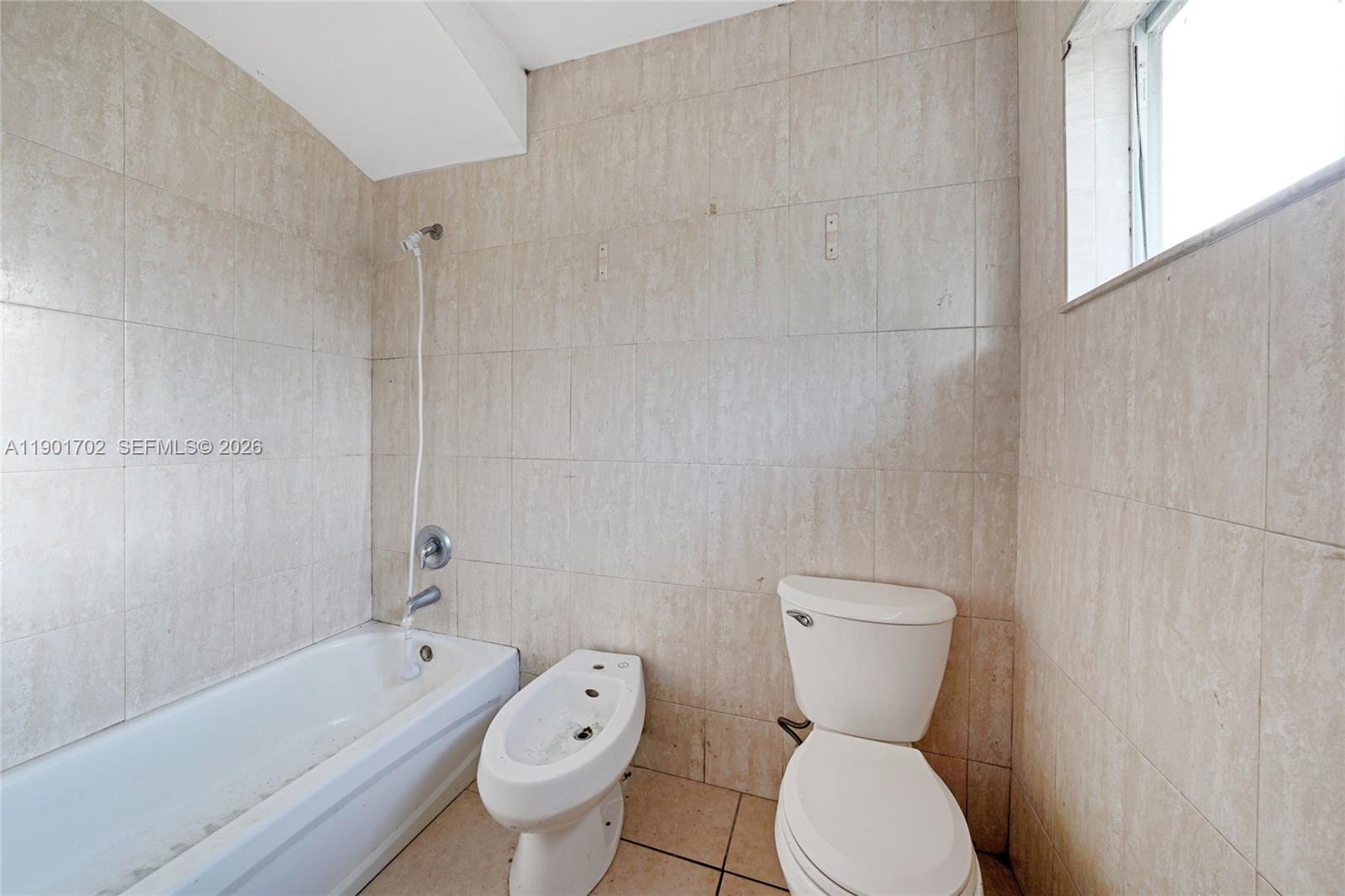 2951 Northwest 57th Street Miami, FL 33142 - Photo 20 of 24 a bathroom with a toilet sink and bathtub
