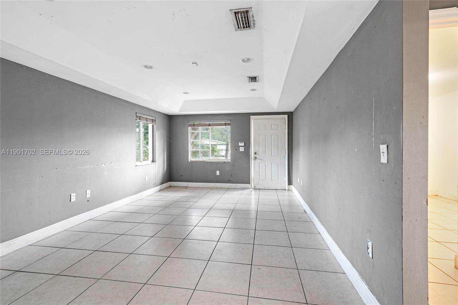 2951 Northwest 57th Street Miami, FL 33142 - Photo 2 of 24 a view of an empty room and window
