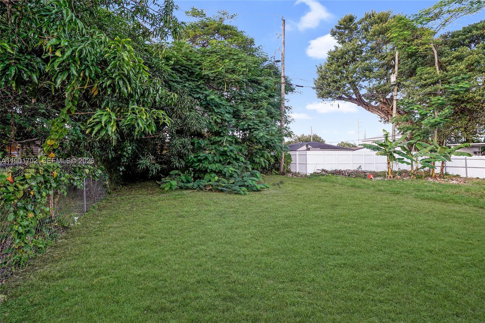 2951 Northwest 57th Street Miami, FL 33142 - Photo 22 of 24 a backyard of a house with lots of green space