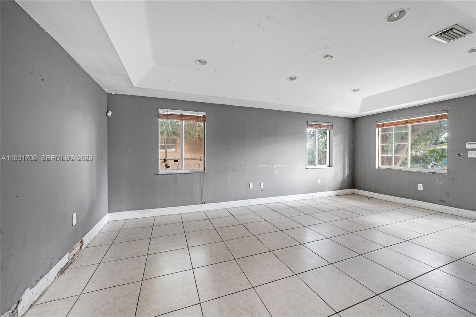 2951 Northwest 57th Street Miami, FL 33142 - Photo 3 of 24 a view of an empty room with a window