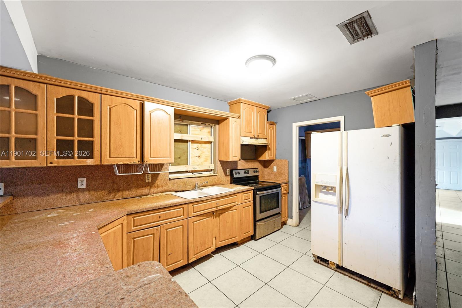 2951 Northwest 57th Street Miami, FL 33142 - Photo 7 of 24 a kitchen with a sink appliances and cabinets