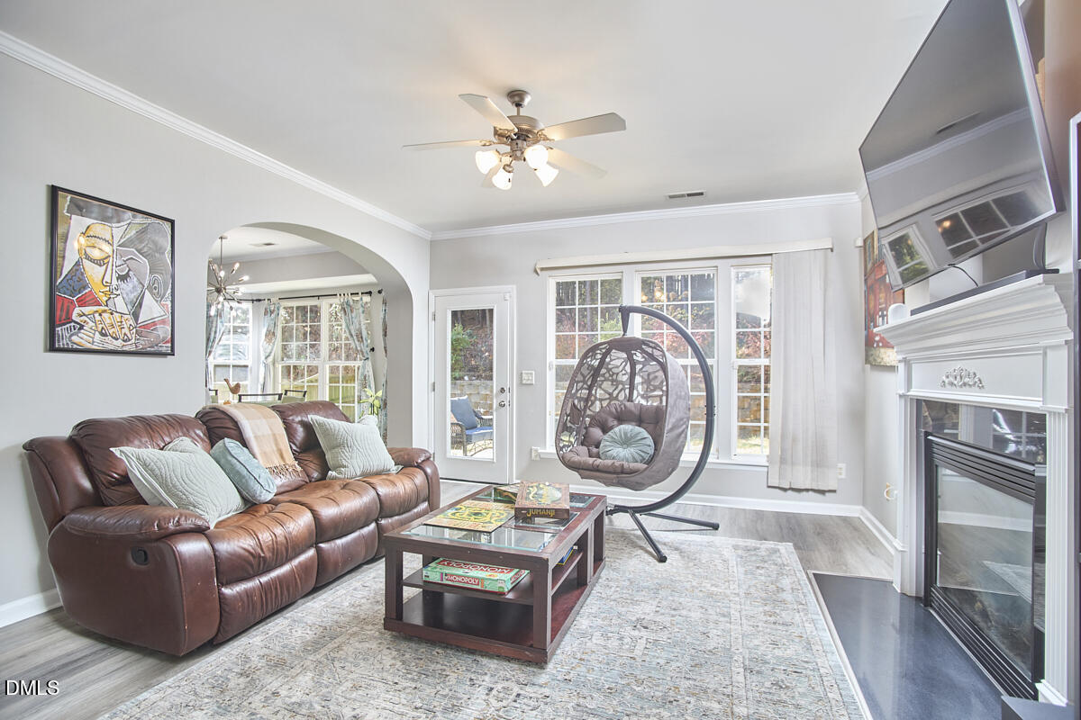 8441 Lunar Stone Place Raleigh, NC 27613 - Photo 15 of 43 a living room with furniture a chandelier and a window