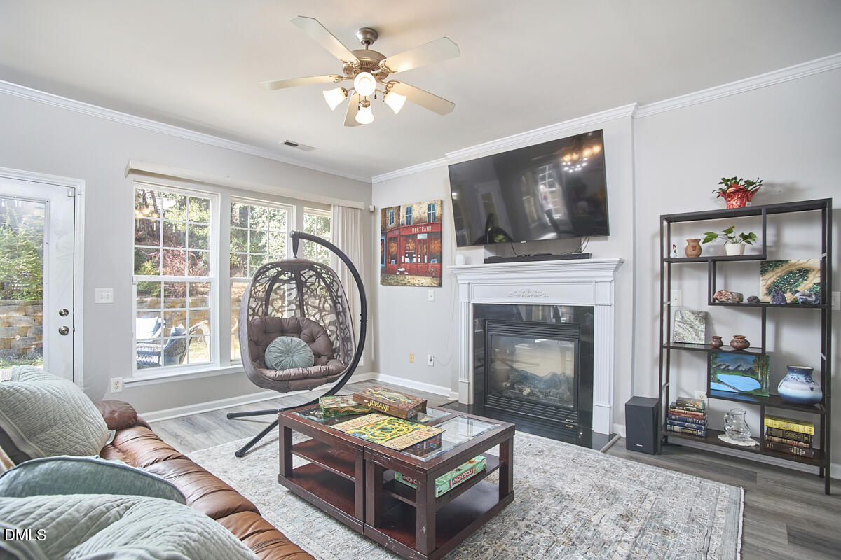 8441 Lunar Stone Place Raleigh, NC 27613 - Photo 16 of 43 a living room with furniture a flat screen tv and a fireplace