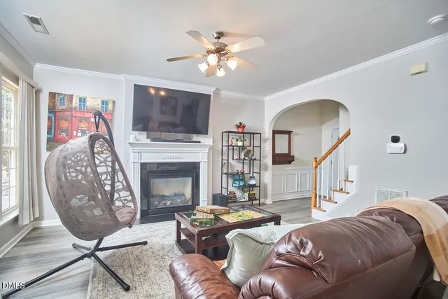 a dining room with furniture a window and wooden floor