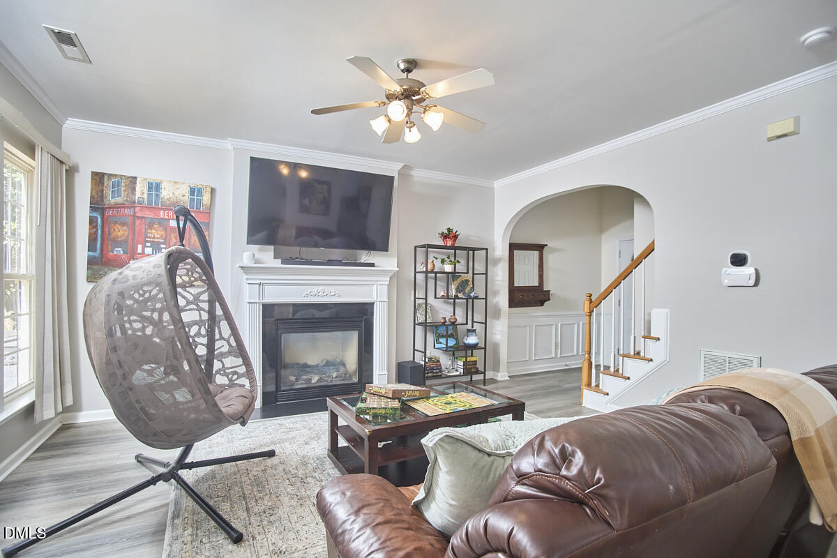 8441 Lunar Stone Place Raleigh, NC 27613 - Photo 17 of 43 a living room with furniture a flat screen tv and a fireplace
