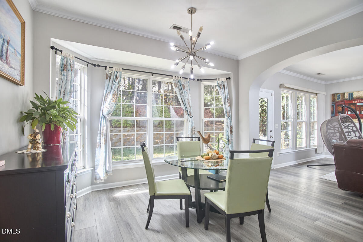 8441 Lunar Stone Place Raleigh, NC 27613 - Photo 20 of 43 a view of a dining room with furniture window and wooden floor