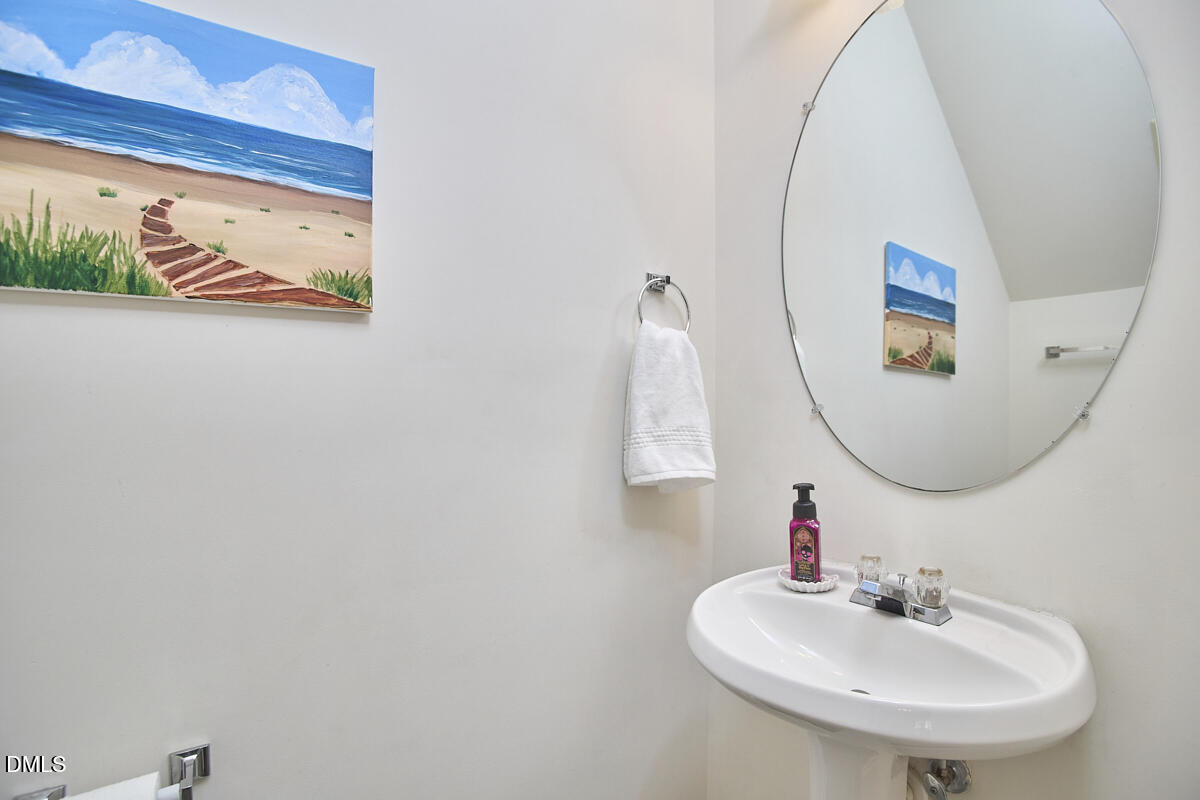8441 Lunar Stone Place Raleigh, NC 27613 - Photo 24 of 43 a bathroom with a sink and a mirror