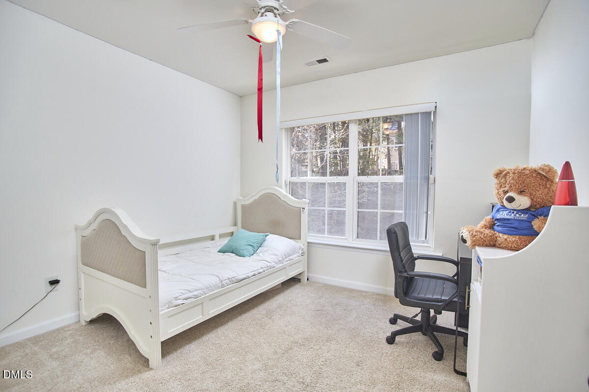 8441 Lunar Stone Place Raleigh, NC 27613 - Photo 25 of 43 a bedroom with furniture and a window