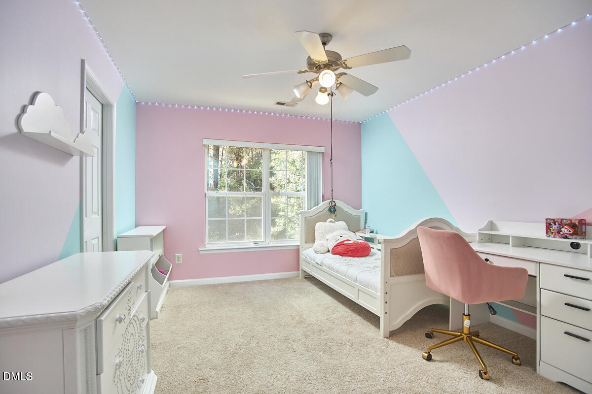 8441 Lunar Stone Place Raleigh, NC 27613 - Photo 26 of 43 a living room with furniture and a chandelier
