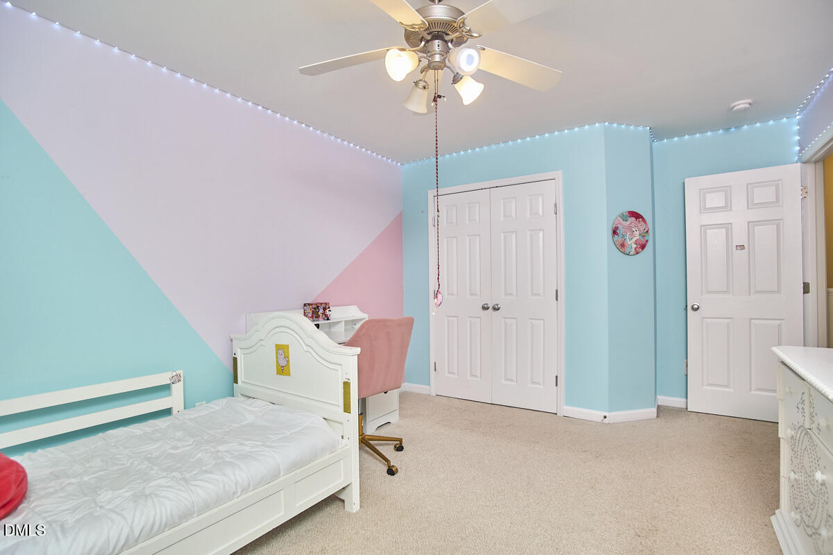 8441 Lunar Stone Place Raleigh, NC 27613 - Photo 27 of 43 a bedroom with furniture and a chandelier