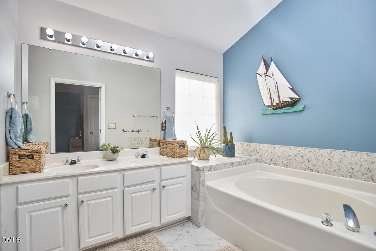 8441 Lunar Stone Place Raleigh, NC 27613 - Photo 30 of 43 a bathroom with a double vanity sink mirror and bathtub