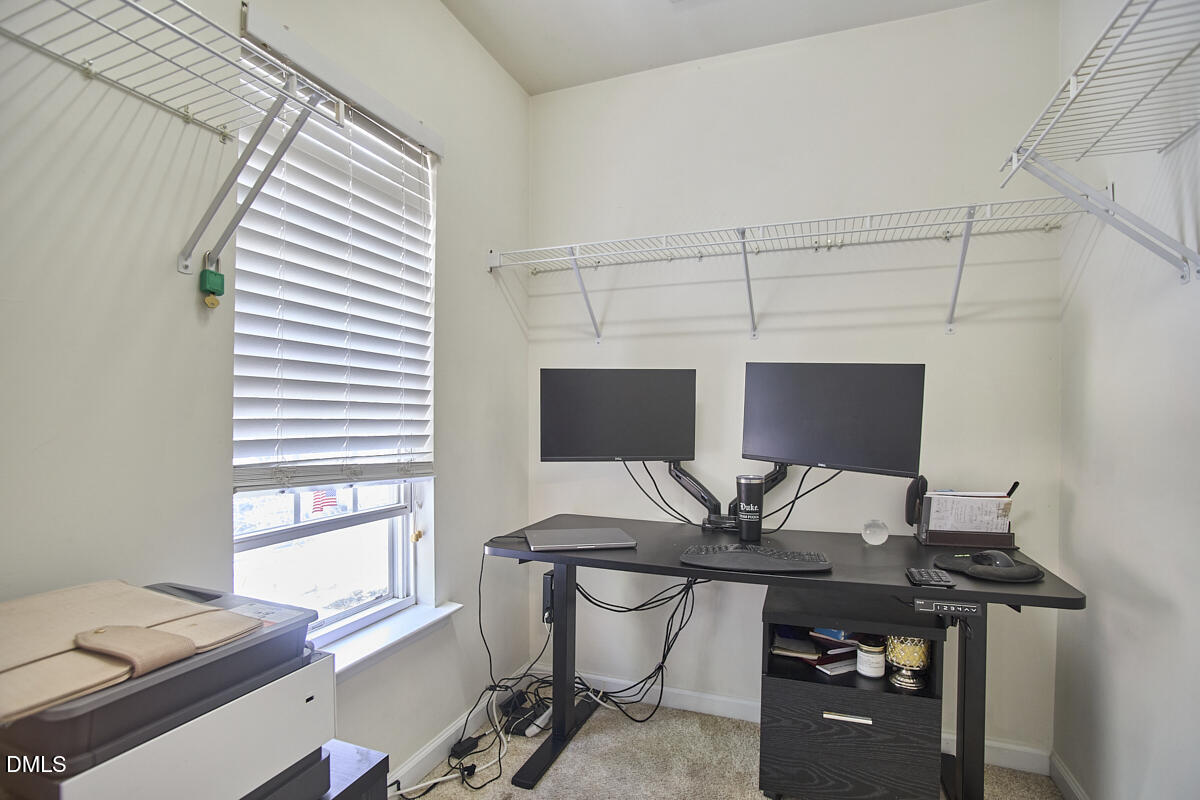8441 Lunar Stone Place Raleigh, NC 27613 - Photo 32 of 43 a view of a workspace with furniture and a window