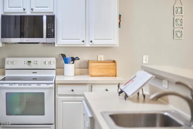 a stove top oven sitting inside of a kitchen