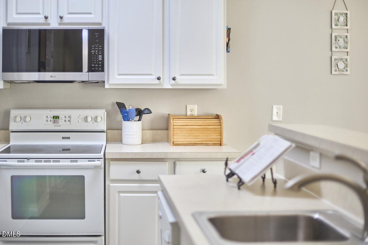 8441 Lunar Stone Place Raleigh, NC 27613 - Photo 37 of 43 a kitchen with a sink cabinets and appliances