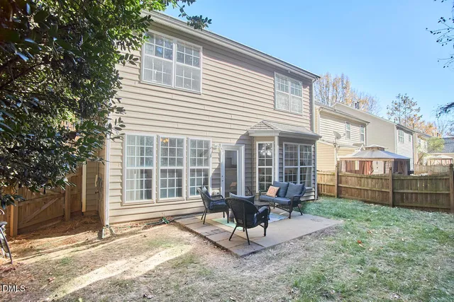 a view of a house with backyard wooden and sitting area