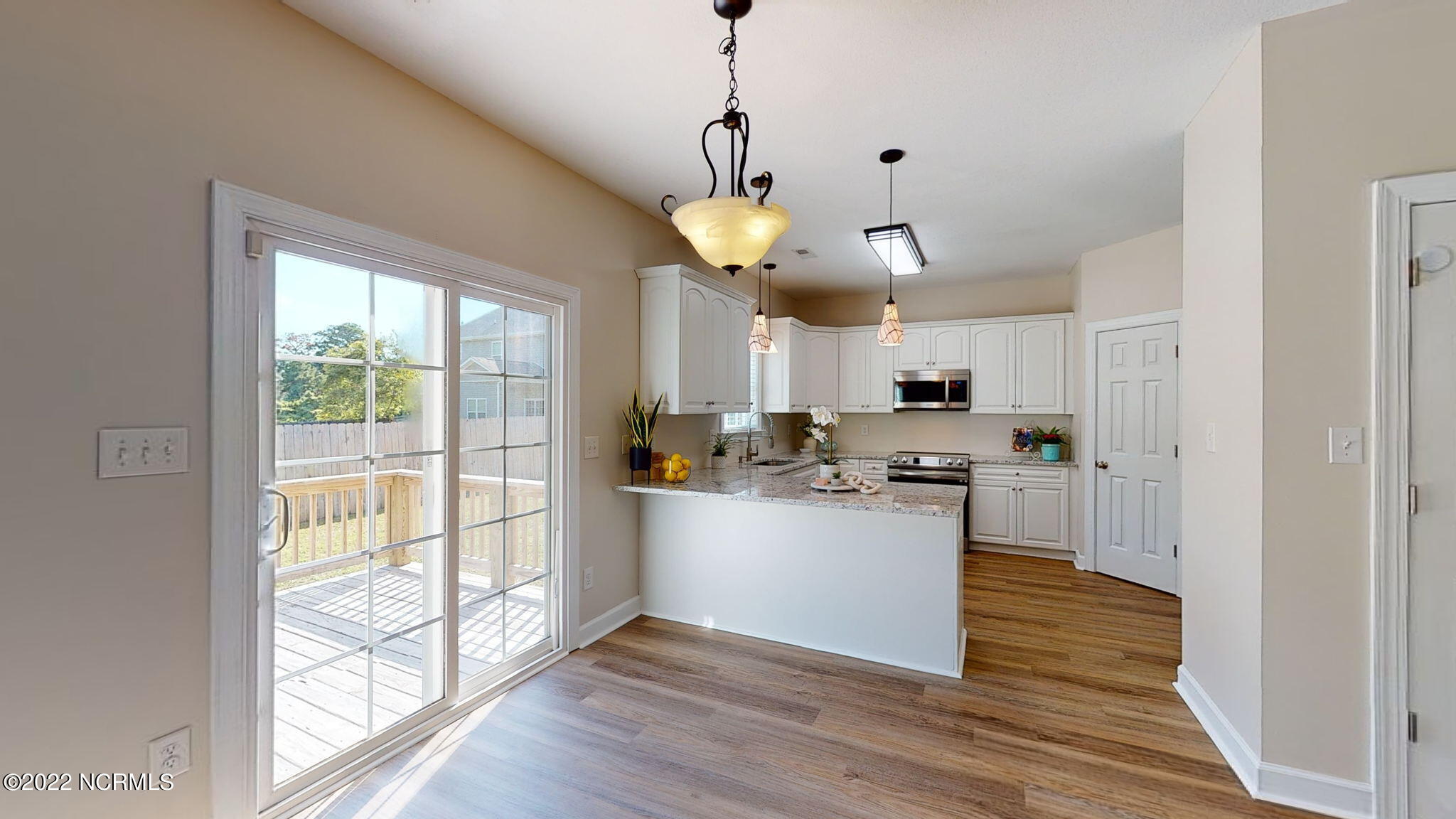 200 Bell Ridge Lane Hubert, NC 28539 - Photo 20 of 59 Dining nook and breakfast bar. NEW GRANITE & NEW LVP!