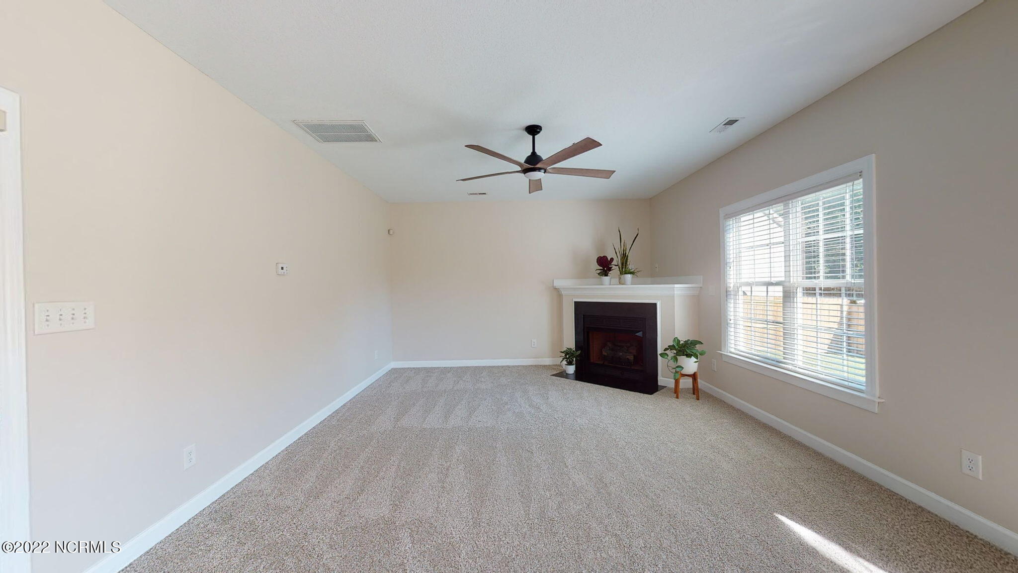 200 Bell Ridge Lane Hubert, NC 28539 - Photo 23 of 59 Fabulous space in the Living Room w/ NEW 60" ceiling fan! Gas fireplace, 2" faux wood blinds, and lots of natural light throughout the day. TV shelving above the gas fireplace.