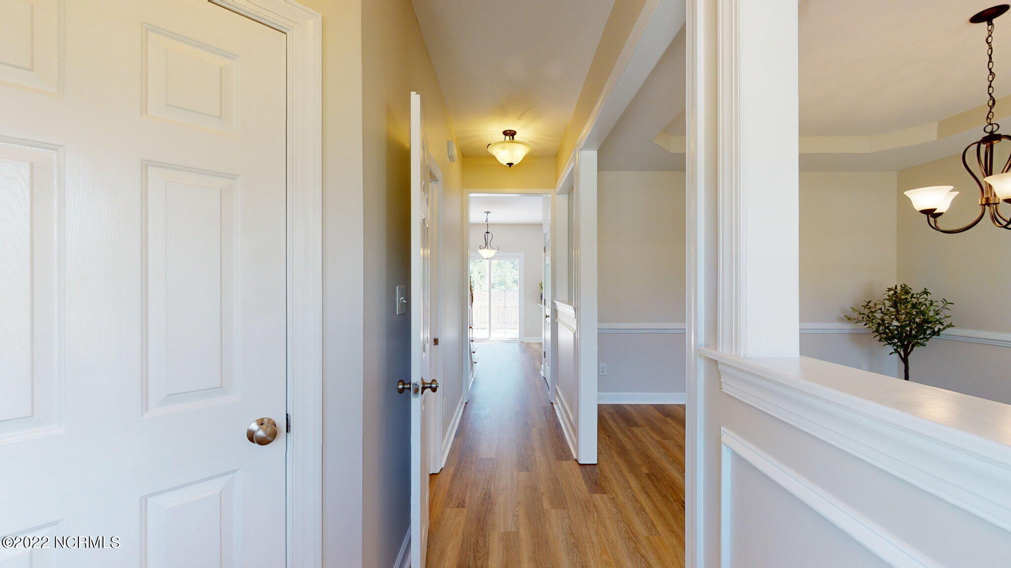 200 Bell Ridge Lane Hubert, NC 28539 - Photo 8 of 59 Accent trim work on the knee-wall partitions. Foyer with coat closet on the left, half bath on the left and the Formal Dining Room on the right with an additional closet on the right with shelving.