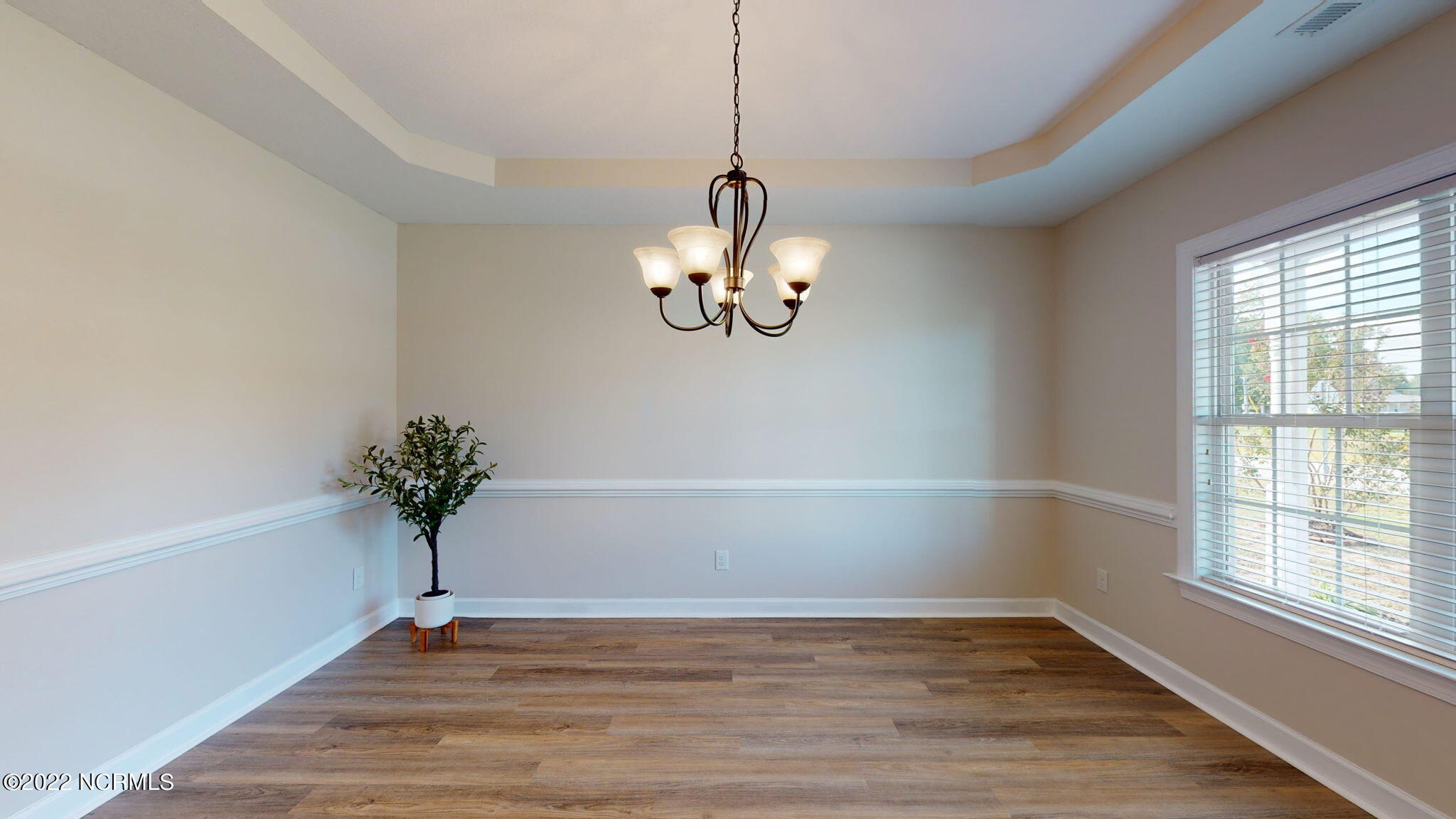 200 Bell Ridge Lane Hubert, NC 28539 - Photo 10 of 59 Large formal dining room, new LVP flooring, w/ tray ceiling and chair rail.