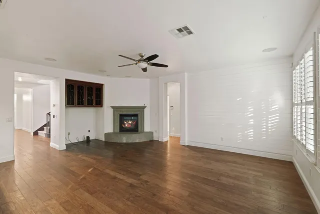 wooden floor in an empty room with a fireplace