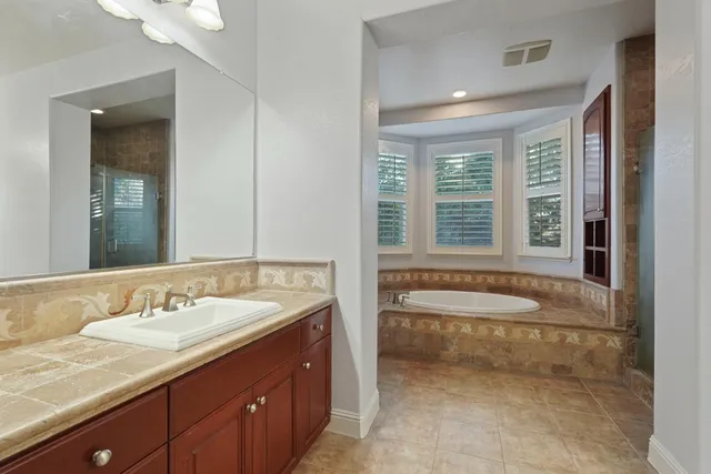 a bathroom with a bathtub and shower