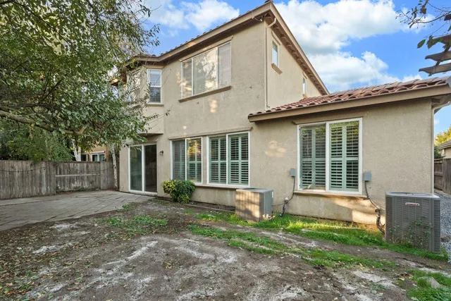 a white building with a bench in front of it